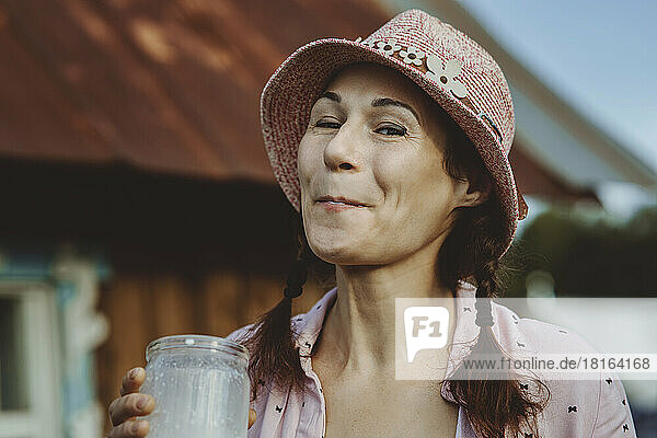 Woman with bucket hat having fresh milk