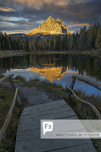 Italy  Veneto  Wooden steps in front of Lake Antorno at dusk with Tre Cime di Lavaredo peaks in background