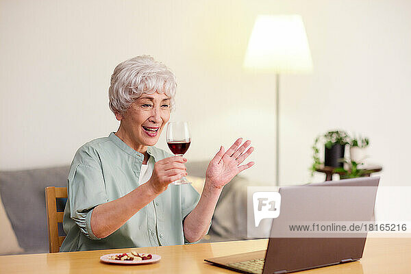 Japanese senior woman having an online drinking party