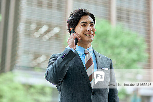Japanese businessman talking on smartphone