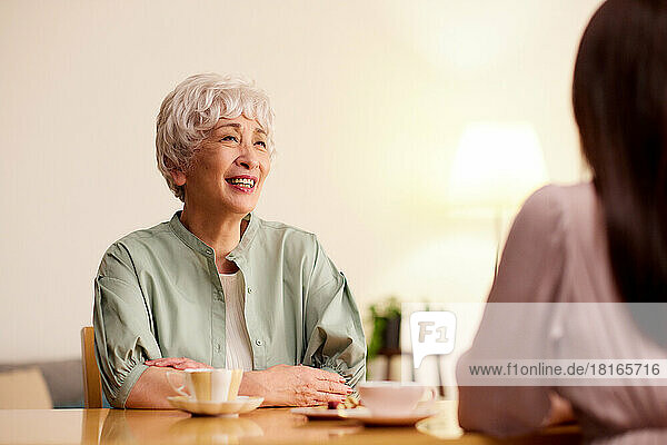 Japanische Seniorin und junge Frau genießen die Teestunde