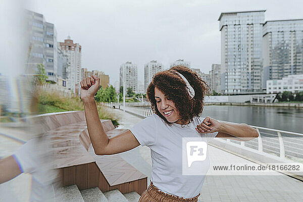 Young woman having fun dancing at promenade