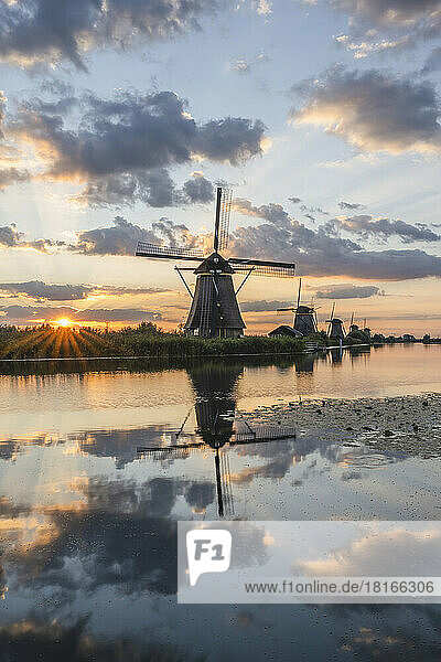 Netherlands  South Holland  Kinderdijk  Countryside river and historic windmills at sunset