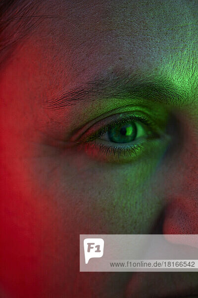 Eye of woman with reflection of red and green light