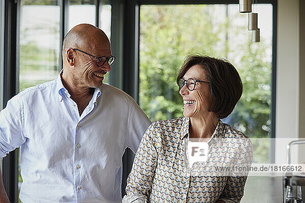 Cheerful senior man with woman at home
