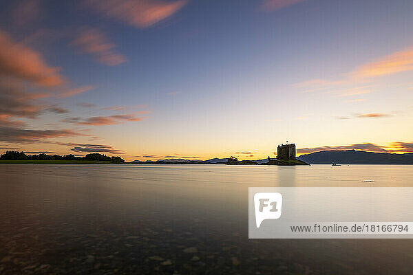 Scenic view of Castle Stalker on Loch Linnhe at sunset  Scotland