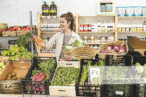 Happy customer buying vegetables in greengrocer shop
