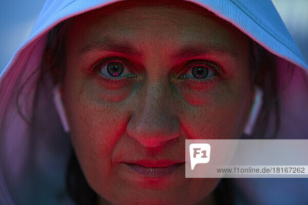 Face of woman with reflection of red light