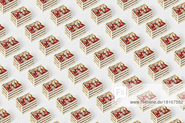 Seamless pattern of wooden boxes with christmas baubles on white background