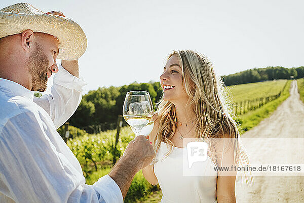Happy woman and man enjoying wine at winery