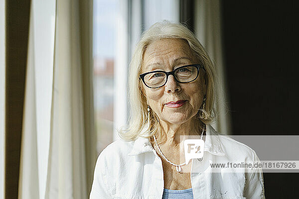 Smiling senior woman wearing eyeglasses at home