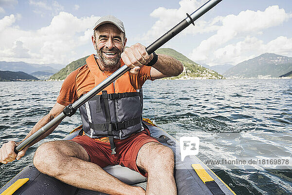 Happy man kayaking on lake