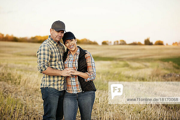 A husband and wife spending some quality time together after accomplishing their fall canola harvest; Alcomdale  Alberta  Canada