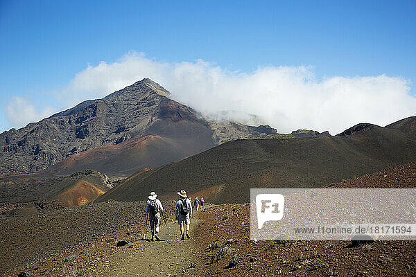 Hikers on Sliding Sands trail in Haleakala Crater  Haleakala National Park; Maui  Hawaii  United States of America