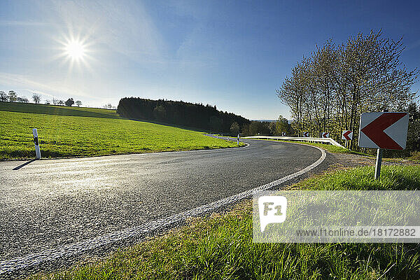 Winding Country Road with Sun in Spring  Neudorf  Amorbach  Odenwald  Bavaria  Germany