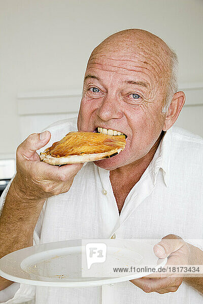 Portrait of Man Eating Slice of Pizza