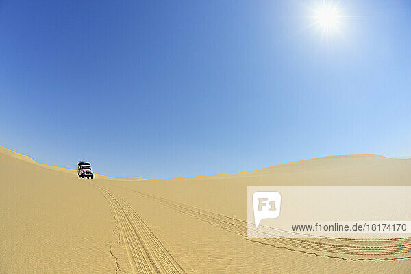 Four Wheel Drive Car in Desert with Blue Sky and Sun  Matruh  Great Sand Sea  Libyan Desert  Sahara Desert  Egypt  North Africa  Africa