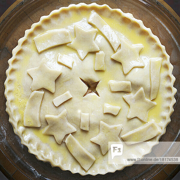 Overhead view of unbaked apple pie with star shaped cut-outs on top  studio shot