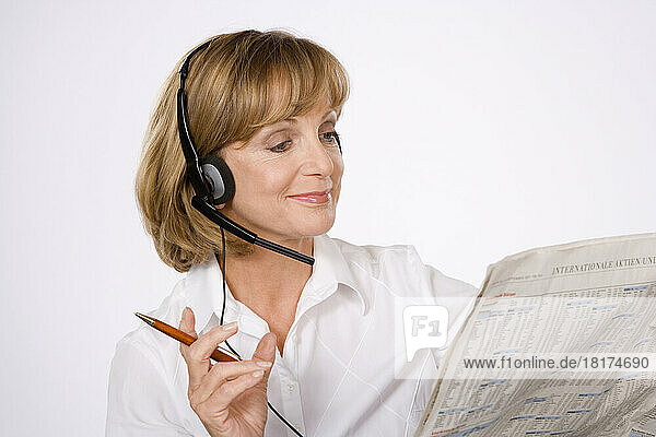 Woman with Headset and Newspaper