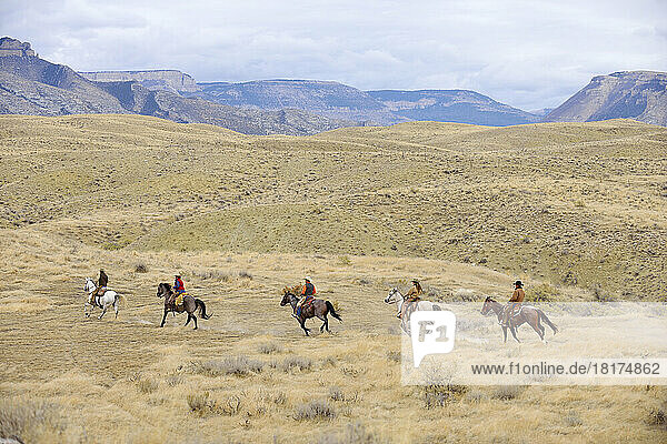Cowboys and Cowgirls riding horse in wilderness  Rocky Mountains  Wyoming  USA