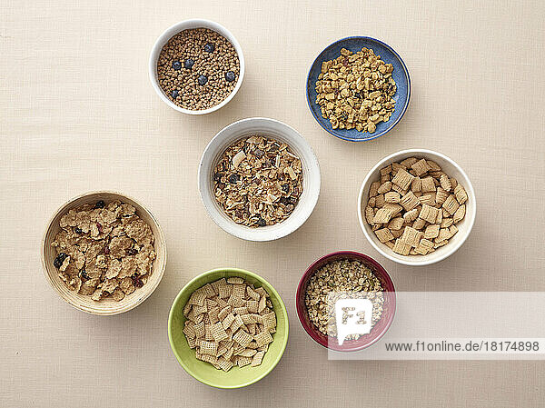 Overhead view of bowls of a variety of healthy cereals  studio shot