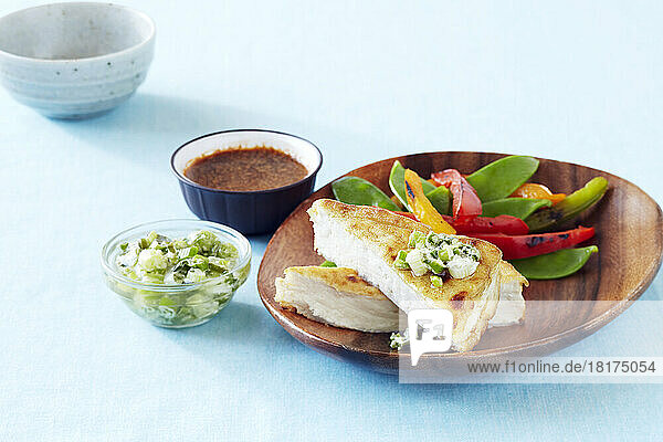 Crispy fried tofu with green onion salsa served with sauteed snow peas and peppers and a dipping sauce