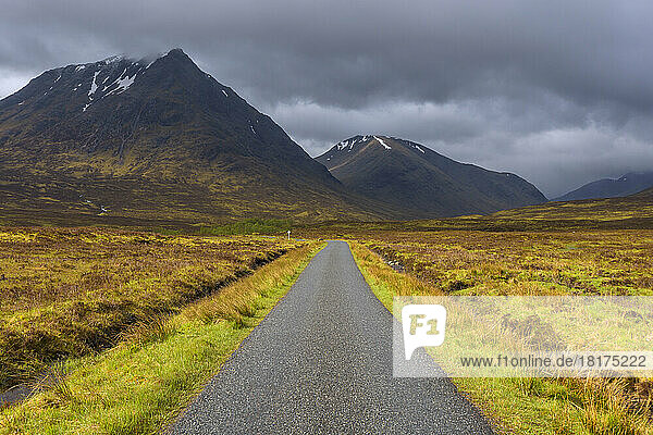 Road with mountains in the highlands at Glen Coe in Scotland  United Kingdom