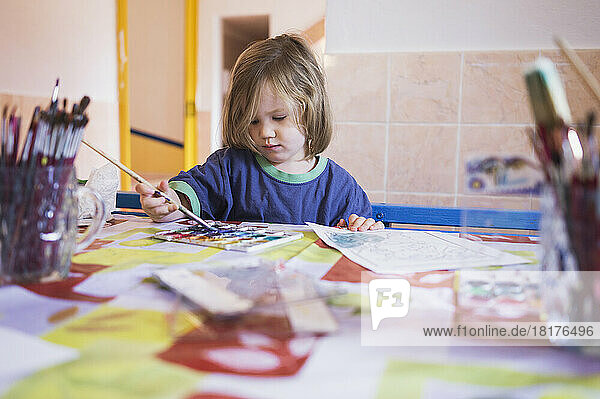 Portrait of Girl Painting in Classroom