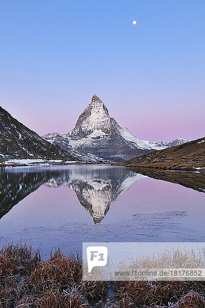 Matterhorn reflected in Lake Riffelsee at Dawn with Moon  Zermatt  Alps  Valais  Switzerland