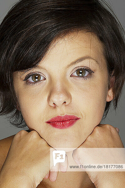 Close-up Portrait of Mid-Adult Woman on Grey Background