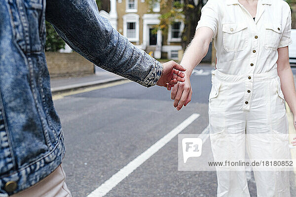 Woman giving hand to friend on street