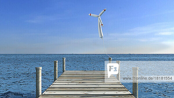 Wind turbine shaped balloon tied to wooden jetty