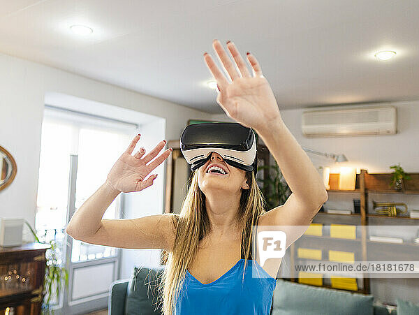 Happy woman wearing virtual reality simulator