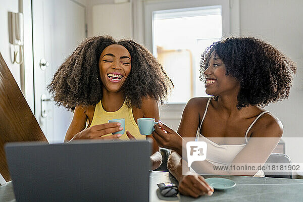 Cheerful freelancers having coffee and working at home
