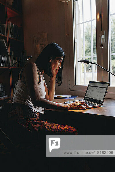 Mature freelancer using laptop at home