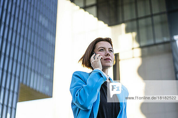 Serious businesswoman talking on smart phone