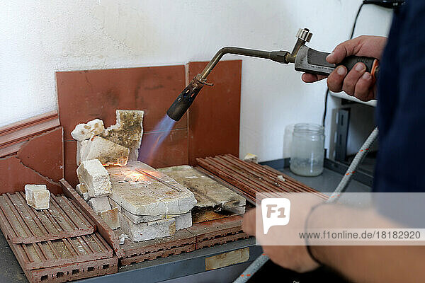 Hands of jeweller using blow torch at workshop