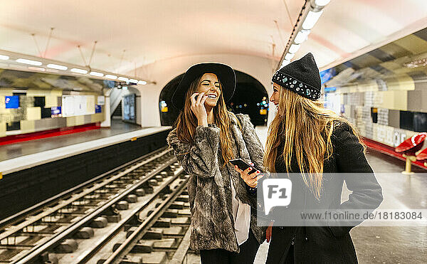 Paris  France  laughing tourists waiting at underground station platform