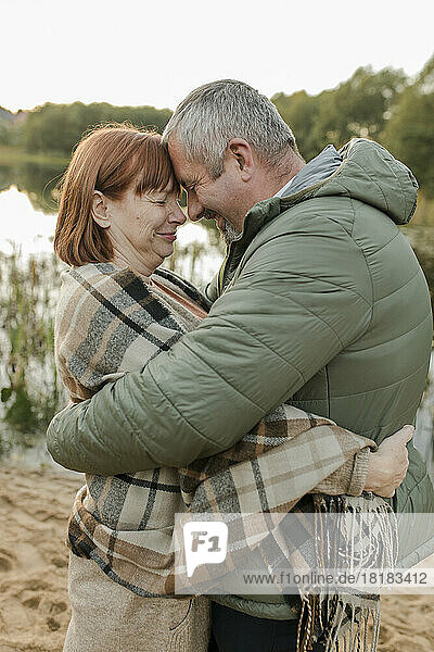 Couple wearing warm clothing embracing each other
