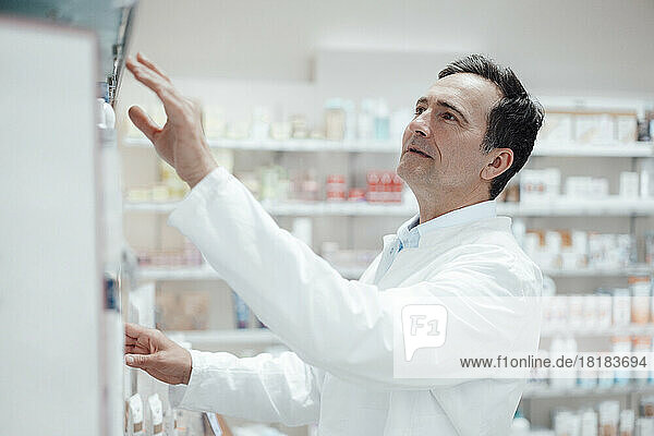Pharmacist analyzing medicines in store