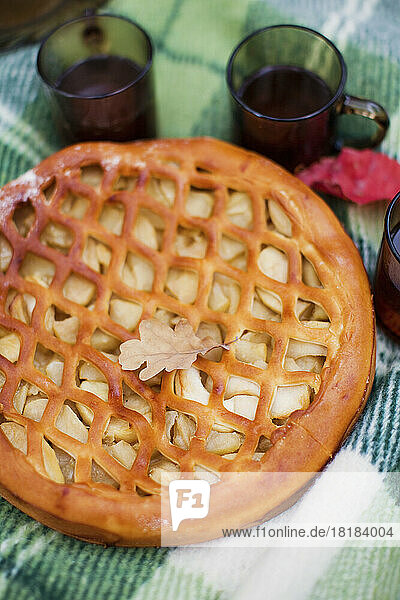 Autumn leaf lying on fresh apple pie