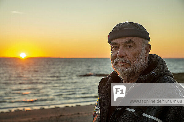 Retired senior man enjoying sunset at beach