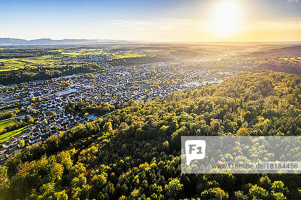Germany  Baden-Wurttemberg  Drone view of sun setting over town in Vilstal valley