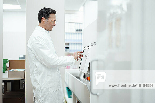 Pharmacist using monitor screen in pharmacy