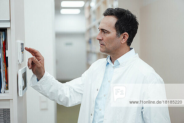 Pharmacist using security system in pharmacy
