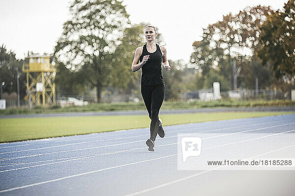 Sportswoman running on sports track