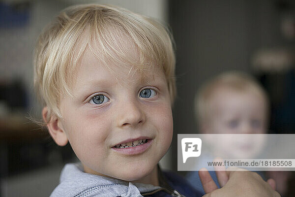 Portrait of smiling little boy at home