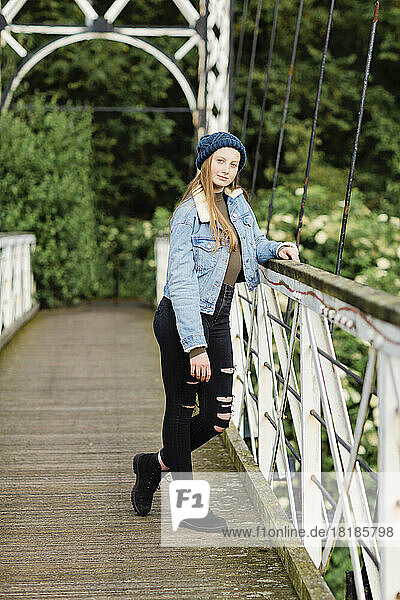 Teenage girl standing on a bridge