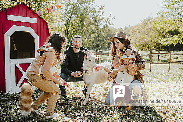Smiling parents with children wearing fox costume at farm