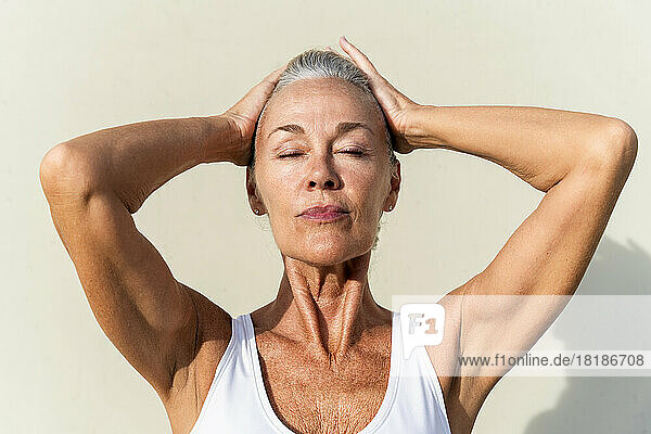 Woman with head in hands on sunny day